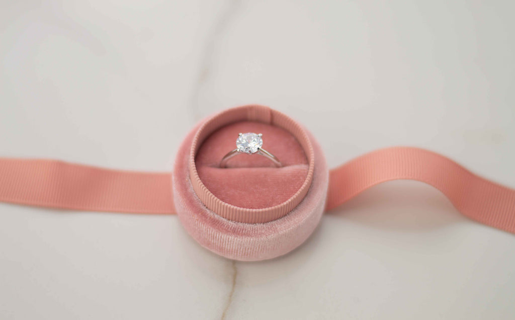 Anillo liso en plata 925 con Zirconia con central corte de diamante en caja de joyas rosa