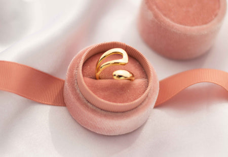 Anillo Statement piece en plata 925 con baño de oro 18k exhibido en caja de anillo rosa
