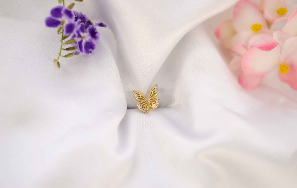 Alas de mariposa color dorado sobre seda blanca