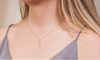 modelo con collar con cadena y pendiente de cuatro mariposas color oro con zirconias